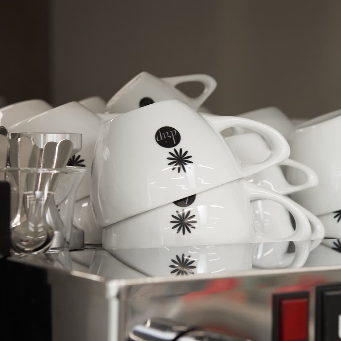 A stack of cups with the logo.